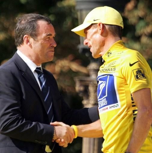 Lance Armstrong and Bernard Hinault on the podium in Paris at the 2004 Tour de France
