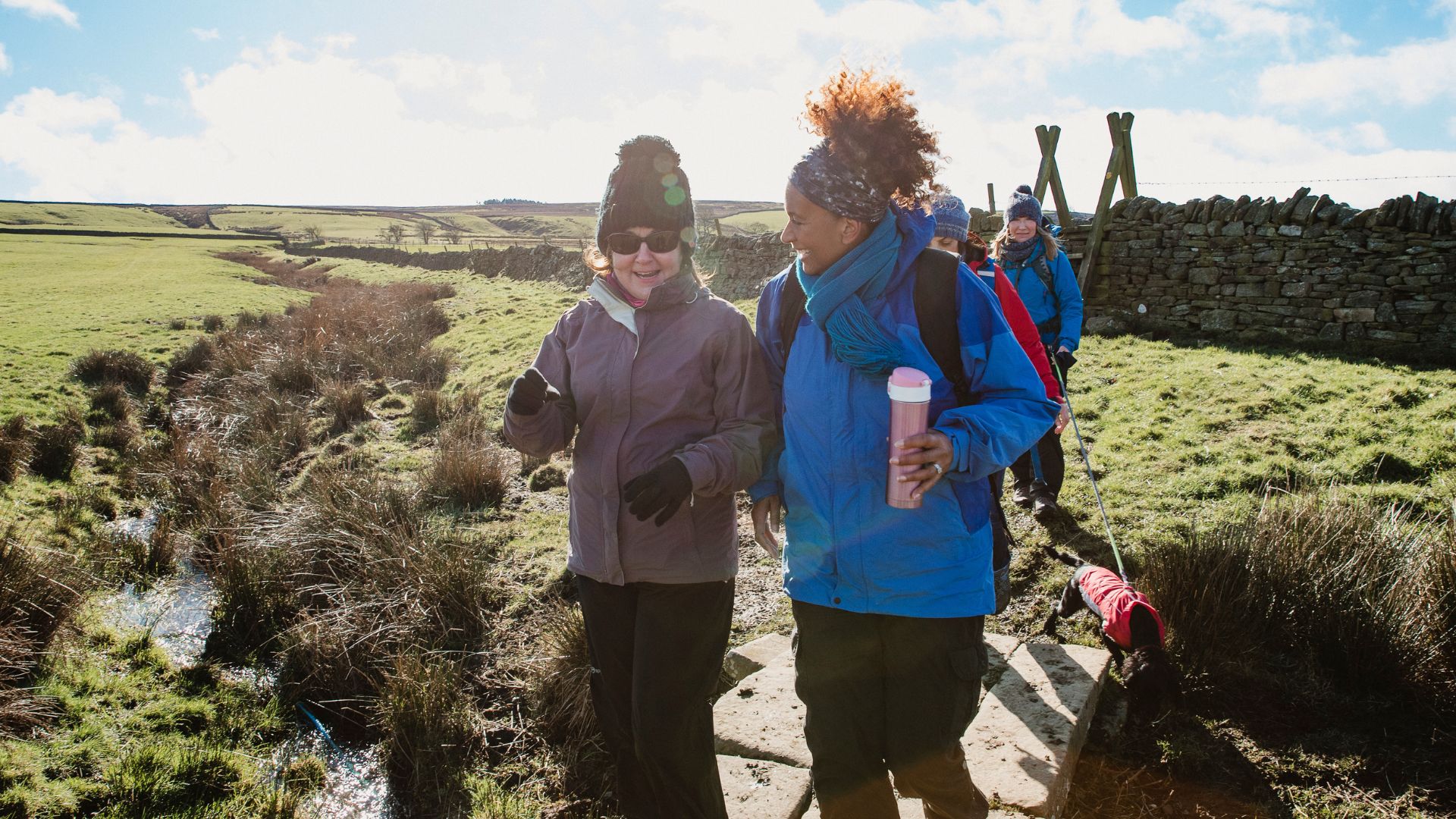 Group of women wearing hiking clothes and carrying water bottles in the cold weather
