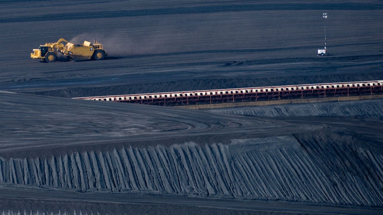 A coal scraper works on a pile of coal at power plant in West Virginia