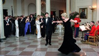 Princess Diana dancing with actor John Travolta at the whiet house, he's in a black tux and she in a black dress