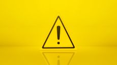 A yellow triangular hazard sign with an exclamation mark in the middle.