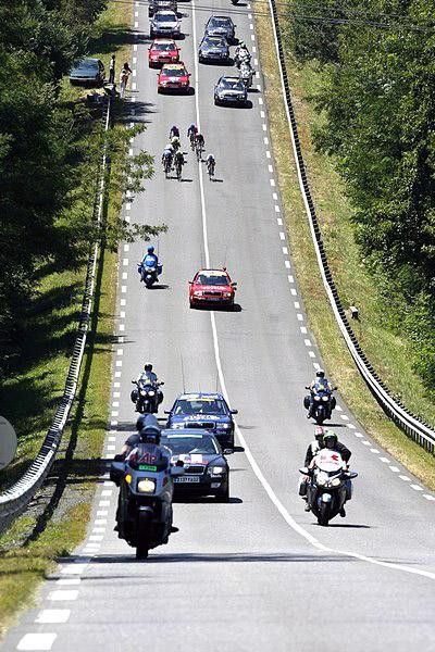 The lead group flies down the road.