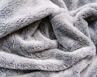 Close up of gray fuzzy fleece blanket