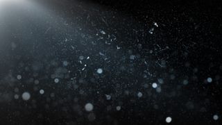 Dust Particles, Sparkles and Light Rays over Black Background.