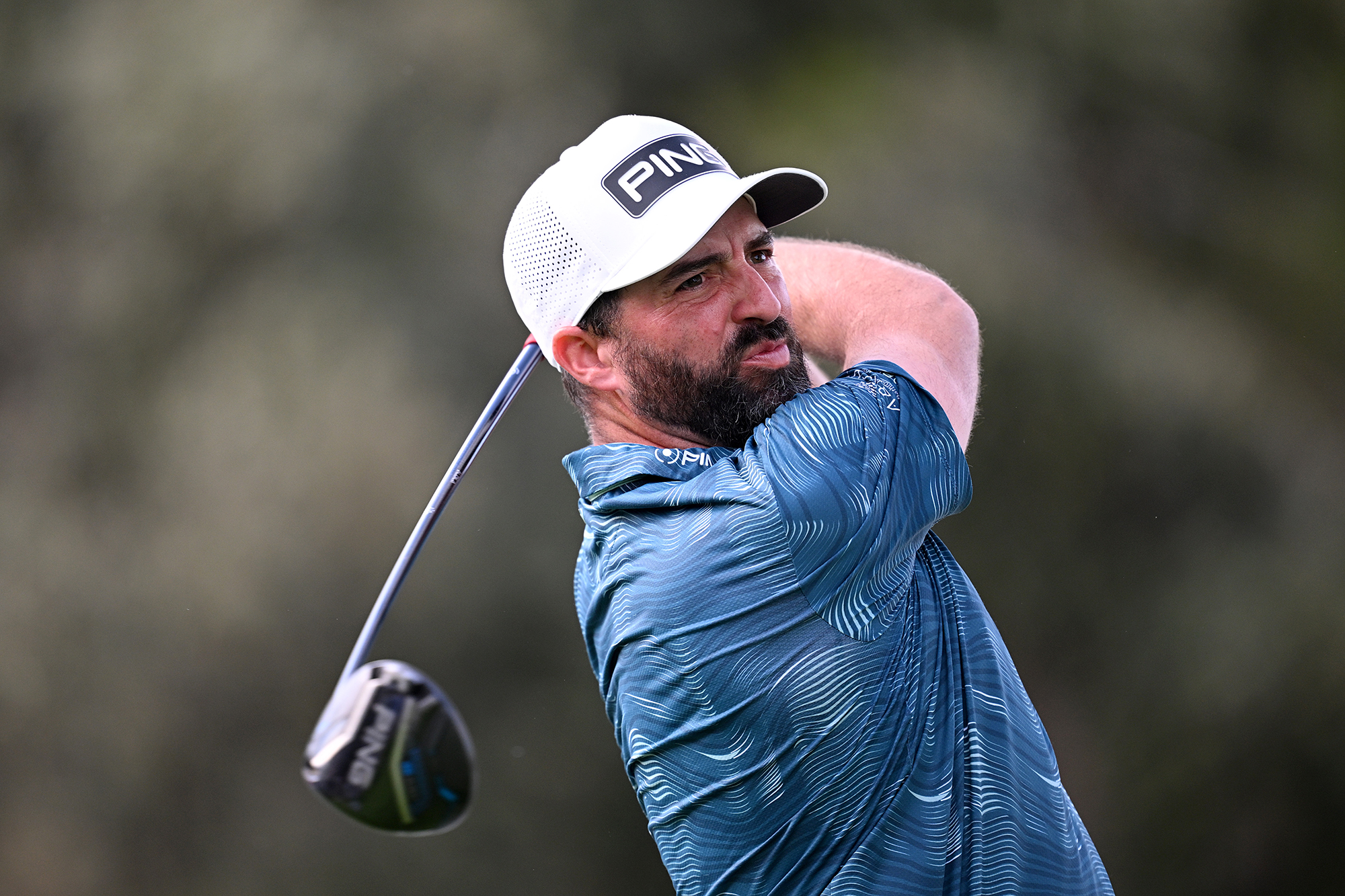 John Parry in the finish position with driver, watching the ball flight of his tee shot