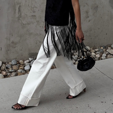 Dawn in white jeans and black tassel top