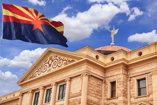 Arizona capitol building with state flag flying above