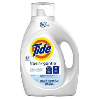 A white plastic bottle of tide free and gentle detergent with a clear plastic messuring cap