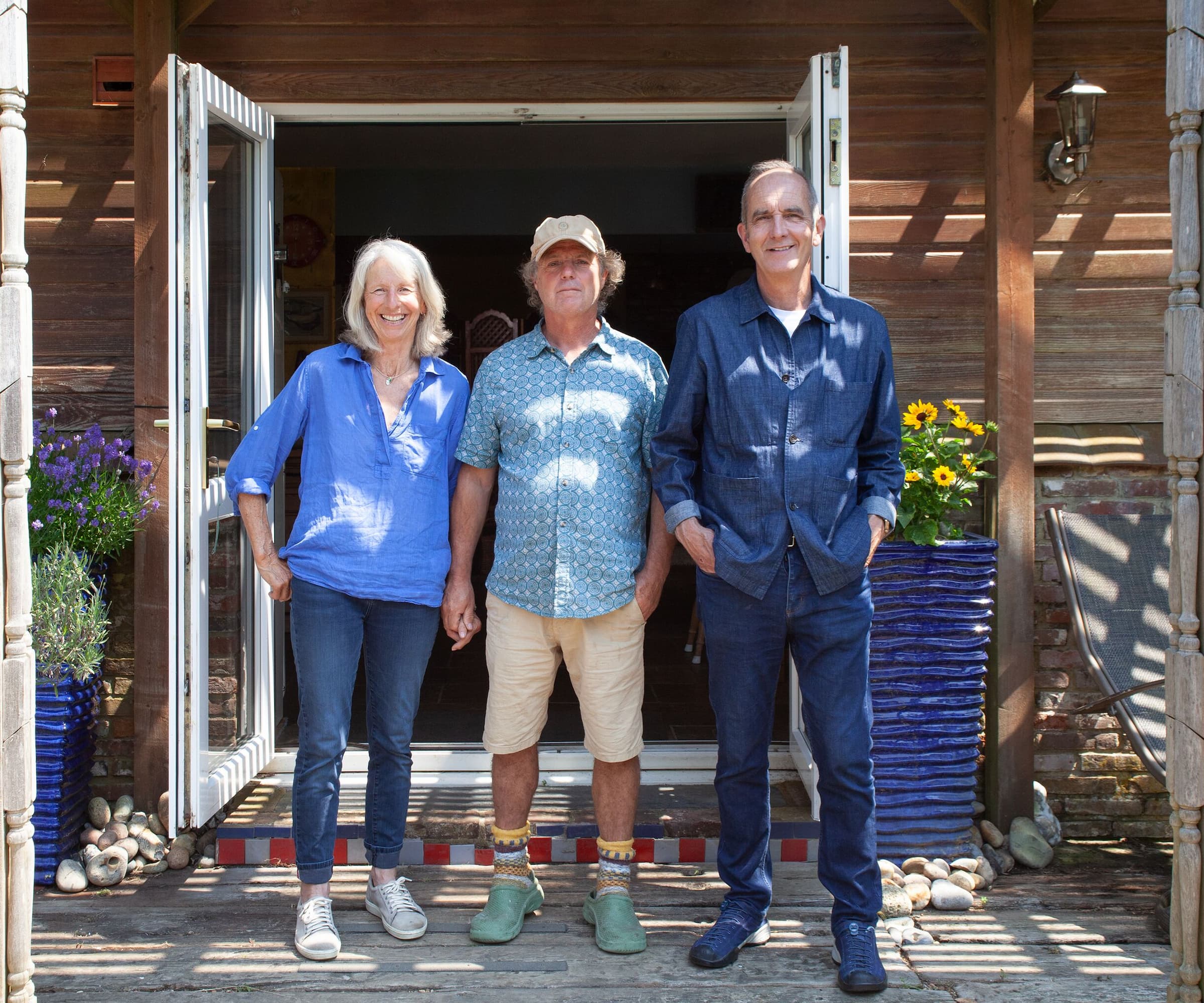 A couple stood with Kevin McCloud in a doorway