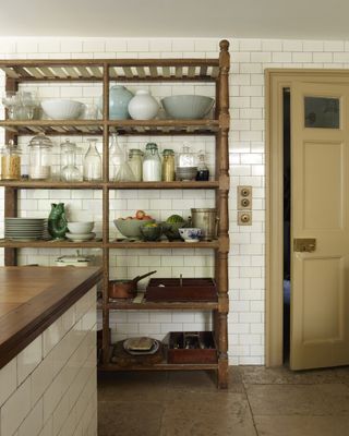 pantry wooden shelving in rustic kitchen.