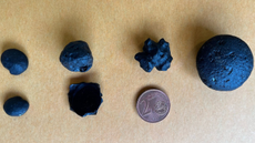 Tektites or &lsquo;cosmic glass&rsquo;.