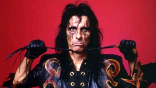 Alice Cooper posing for a photograph with a whip in 1987