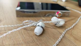 Meze in ear headphones on a table