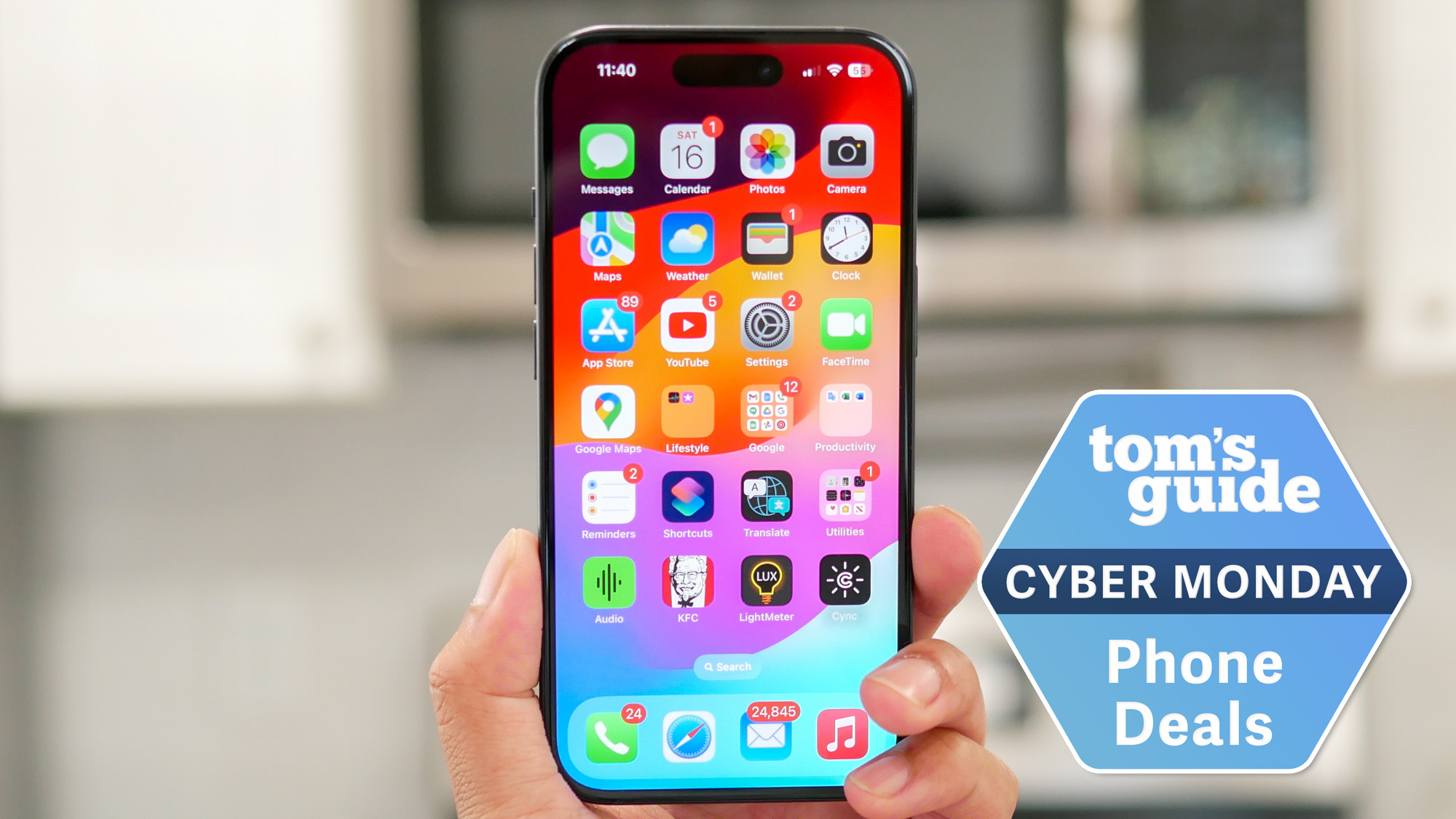 iPhone 15 held in the hand with Cyber Monday badge.