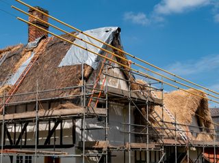 A thatched house in the process of being rethatched