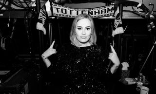Adele poses with a Tottenham scarf while backstage in Chicago in 2016.