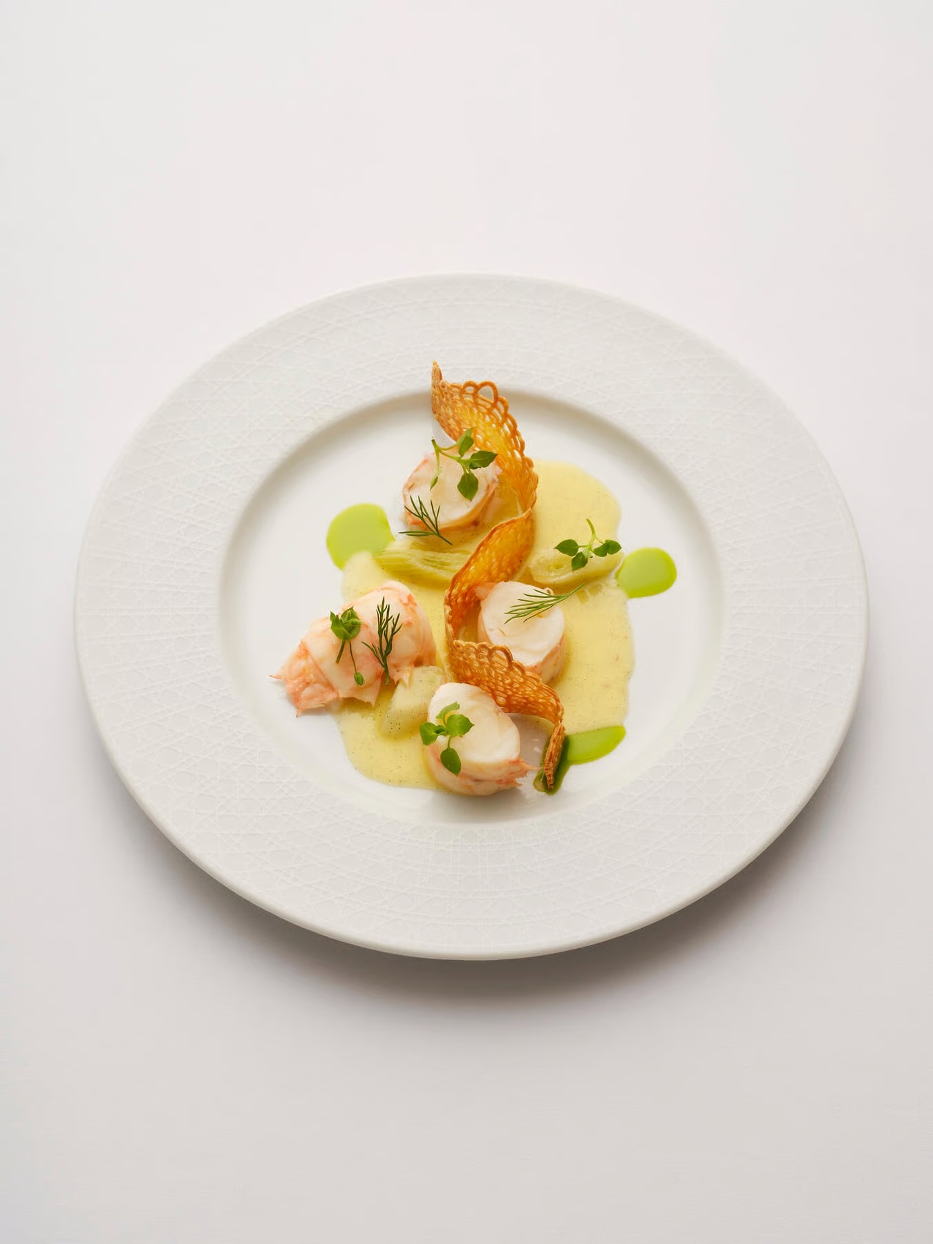 view of some of the dishes at monsieur dior restaurant by mauro colagreco