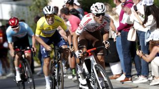 Benoit Cosnefroy (R) of France and AG2R Citröen Team, leads riders up a steep climb at the Tour de Luxembourg, in white and red livery.