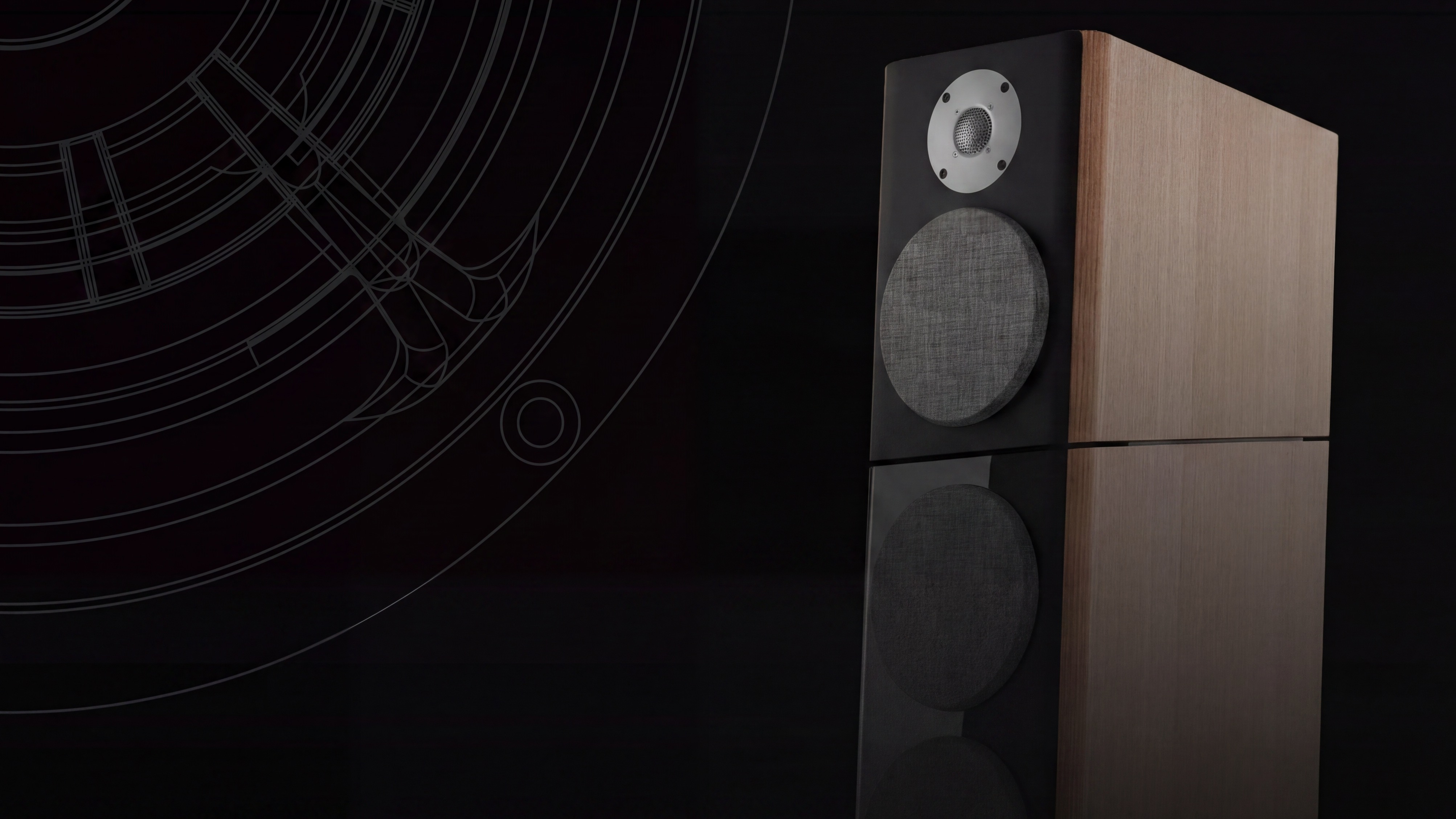 A brown Jamo speaker on a reflective black surface.