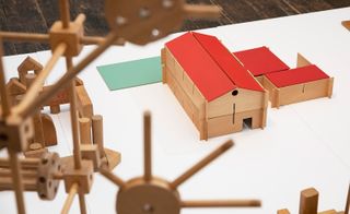 The wooden play tray jigsaws and farmyard barns are formed from slats of wood.