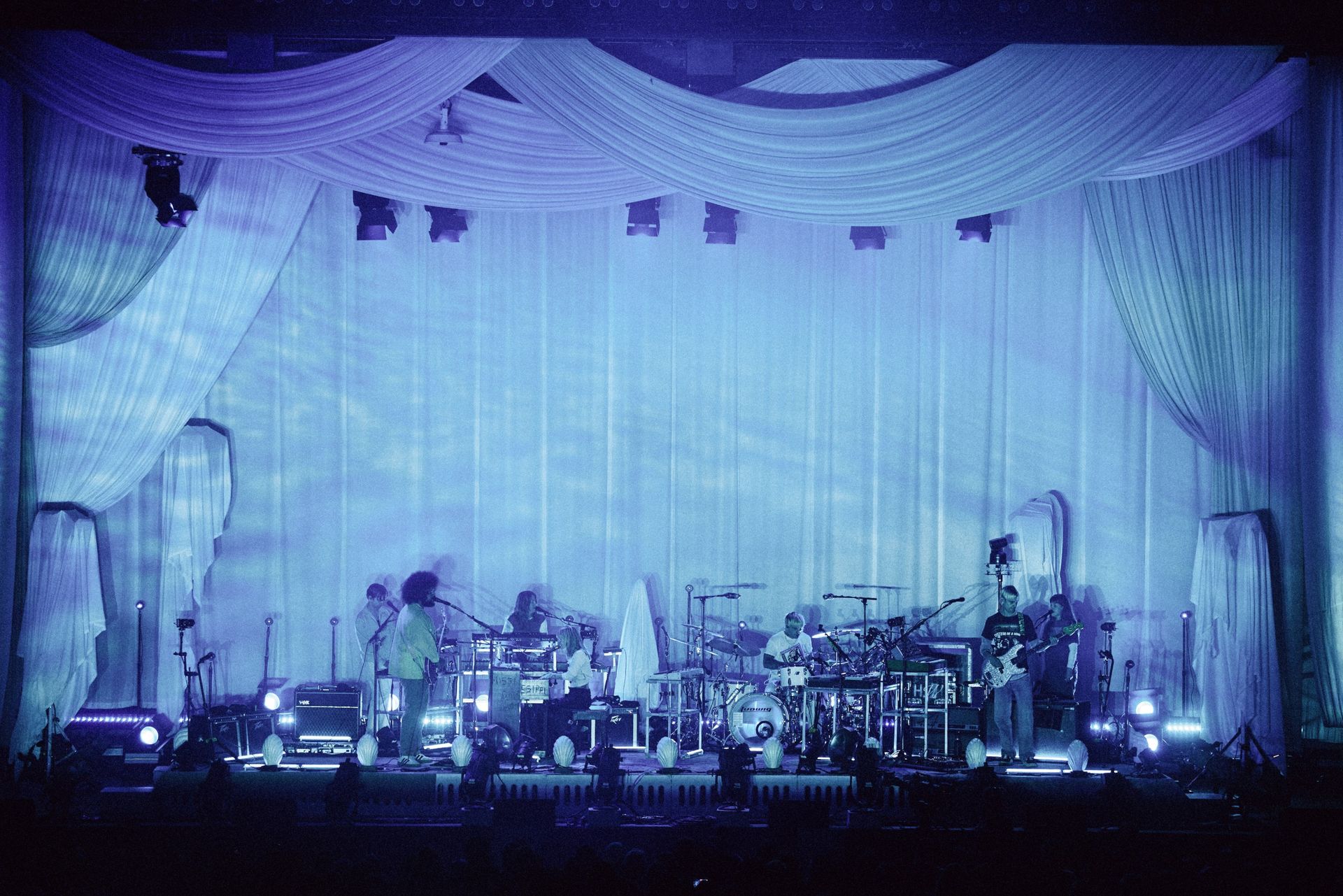 bands on stage in pink light