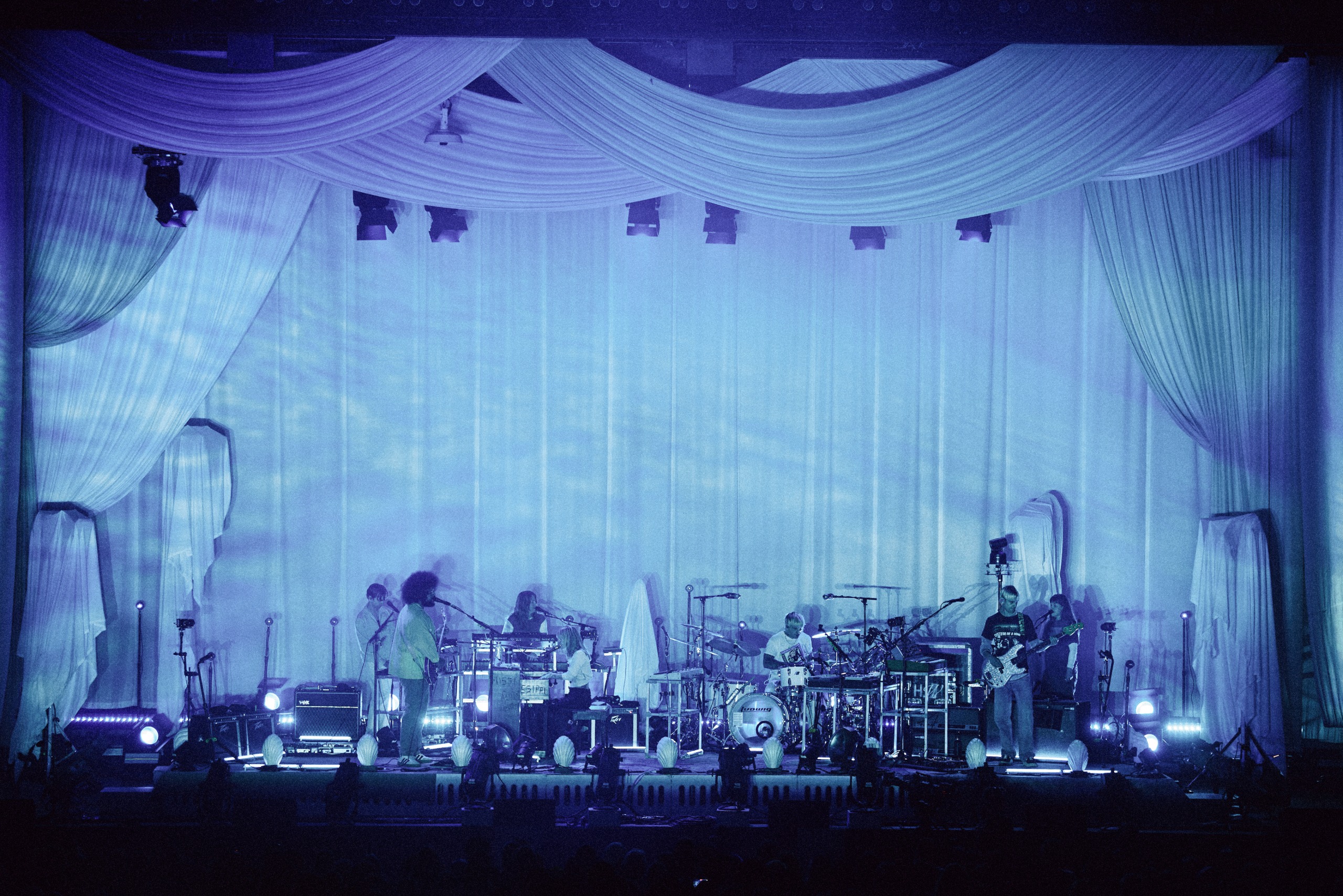 bands on stage in pink light