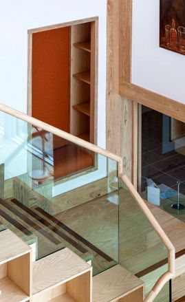 The exterior palette of beech and glass was carried through into the interior and applied here on the stairs