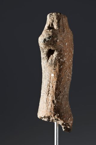 So far, only the figurine's torso, neck and right arm have been found. Archaeologists think it represents a human, probably a male.