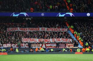 Bayern Munich fans hold a banner reading "Glazers, Sheikh Mansour, all autocrats out! Football belongs to the people" during the UEFA Champions League quarterfinal first leg match between Manchester City and FC Bayern München at Etihad Stadium on April 11, 2023 in Manchester, England.