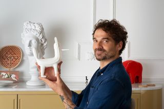 Jaime Hayon at home in Valencia with a miniature figurine that inspired his MOKA Playground design