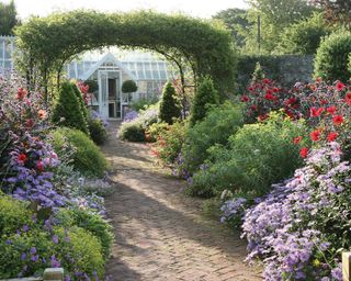 round gazebo from agriframes with climbing plants over path