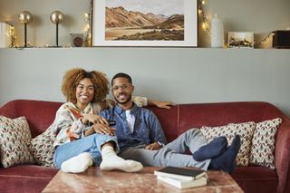 What is a soulmate? Smiling Woman With Boyfriend Watching TV At Home
