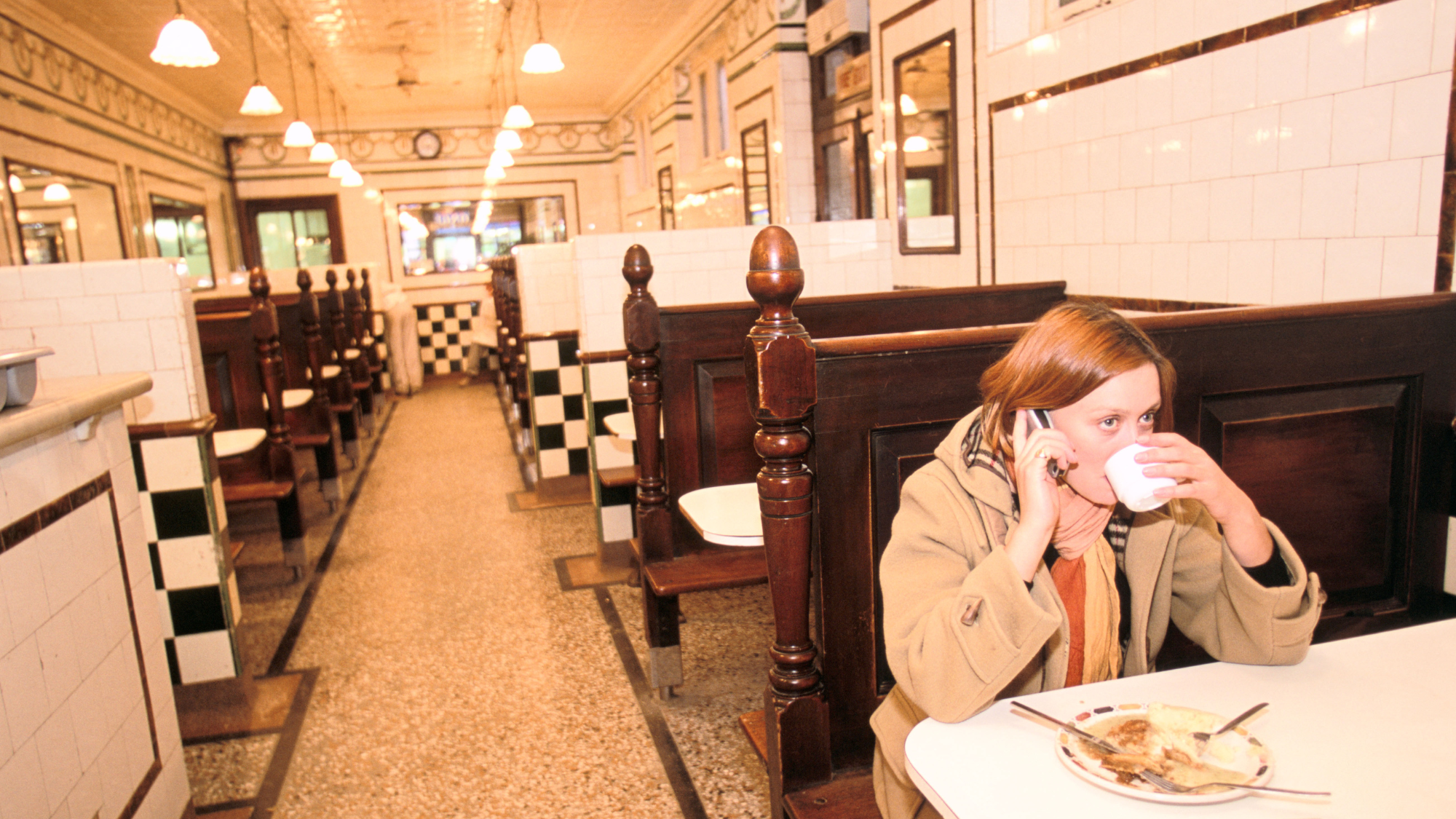 Woman sitting in a pie and mash shop 