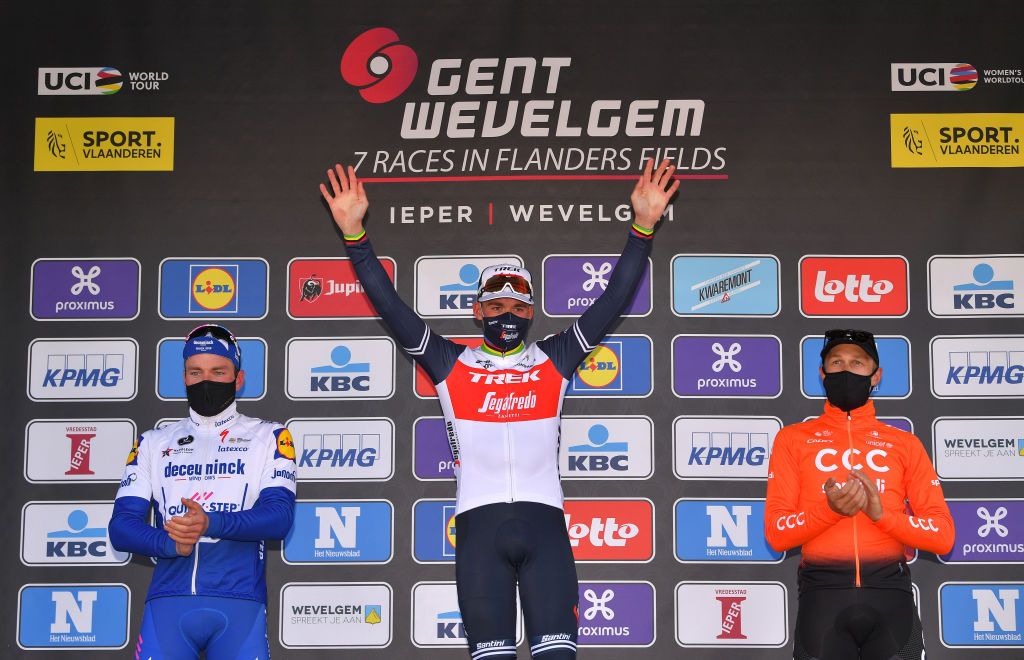 WEVELGEM BELGIUM OCTOBER 11 Podium Florian Senechal of France and Team Deceuninck QuickStep Mads Pedersen of Denmark and Team Trek Segafredo Matteo Trentin of Italy and CCC Team Celebration Trophy Flowers Mask Covid safety measures during the 82nd GentWevelgem In Flanders Fields 2020 Men Elite a 2325km race from Ypres to Wevelgem GentWevelgem FlandersClassic on October 11 2020 in Wevelgem Belgium Photo by Luc ClaessenGetty Images