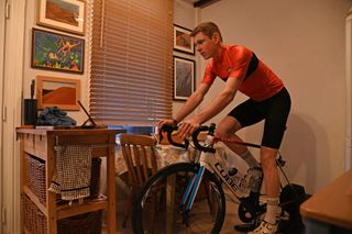 Image shows a rider cycling indoors.