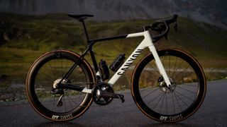 The new Canyon Ultimate, fitted with Ultegra and DT Swiss wheels, stands on a road in front of a grassy hill