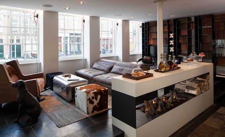 A hotel seating area with bookshelf