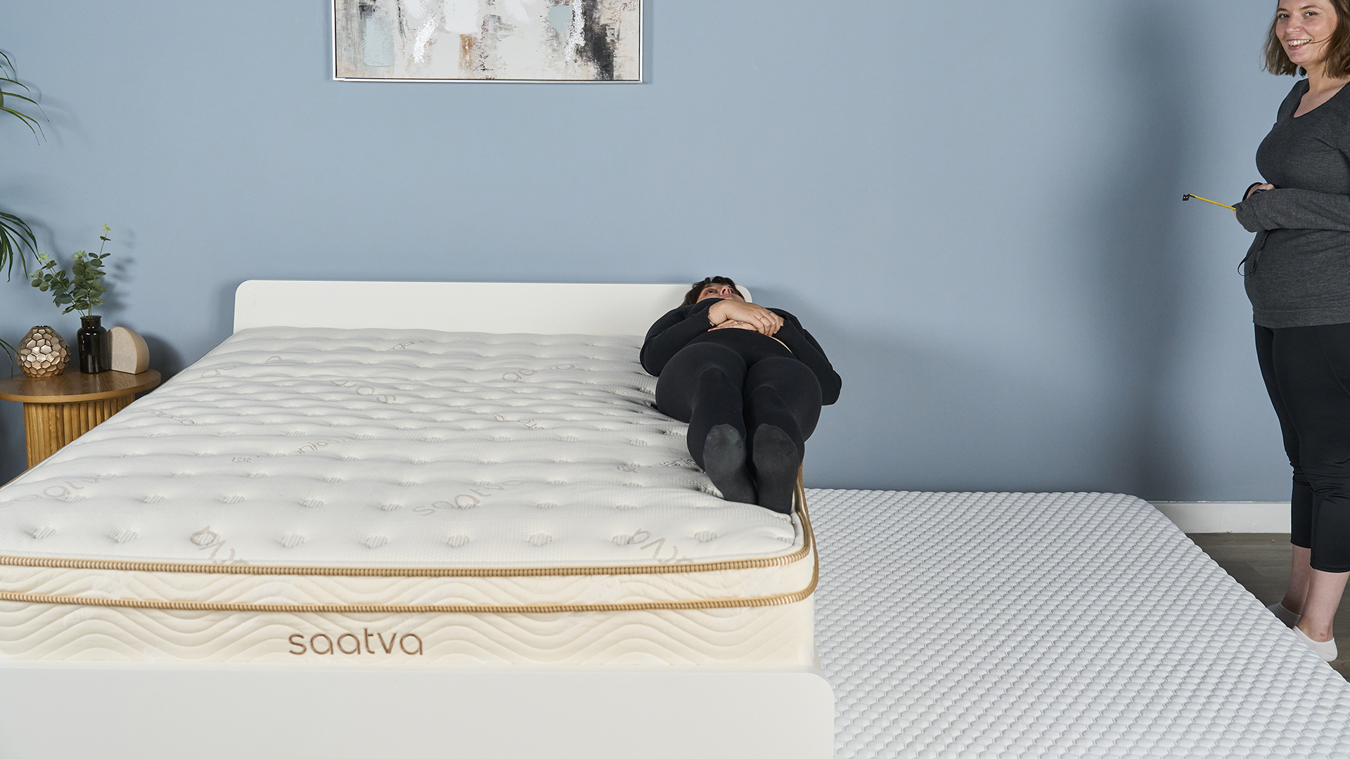 A Tom&#039;s Guide mattress tester performs an edge support test, inching closer to the outer edge of the mattress to see how much effective sleep space the bed offers before the sleeper feels unsupported and uncomfortable