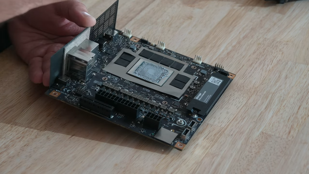 The Framework Desktop mainboard without a cooler, showing off the Strix Halo chip and soldered memory.