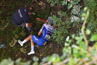 Remco Evenepoel on the ground after falling into a ravine at Il Lombardia in 2020