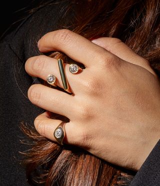 woman wearing rings by Lia Lam on her fingers