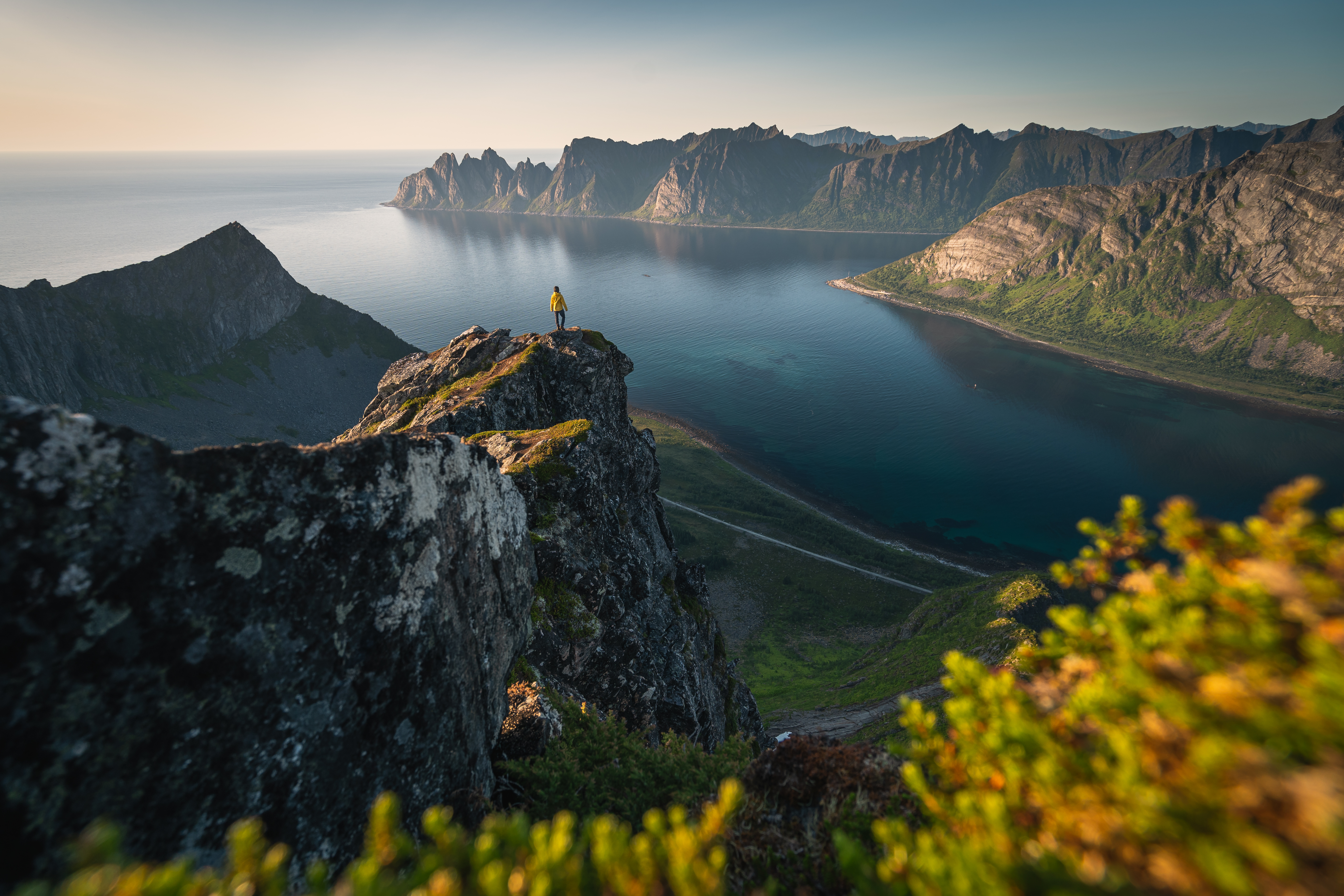 A person stands on top of Husfjellet on Senja Island