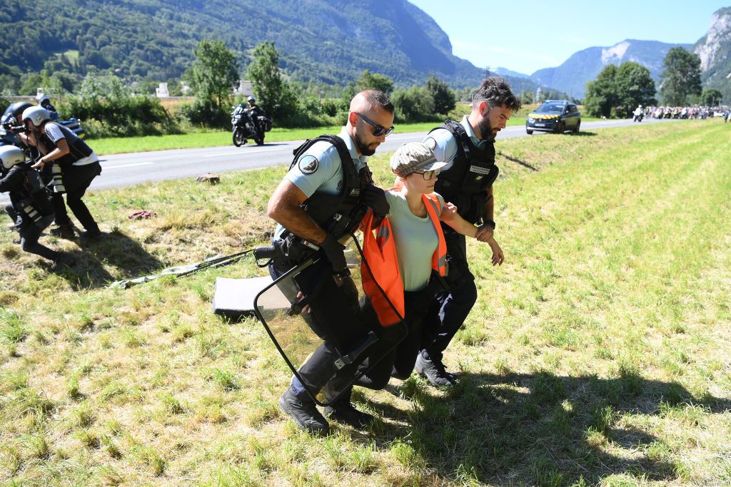 MEGEVE FRANCE JULY 12 The police arrest protesters in defending Mont Blanc environment that block the route during the 109th Tour de France 2022 Stage 10 a 1481km stage from Morzine to Megve 1435m TDF2022 WorldTour on July 12 2022 in Megeve France Photo by Alex BroadwayGetty Images
