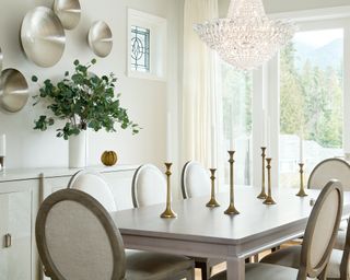 A white dining room with statement crystal chandelier