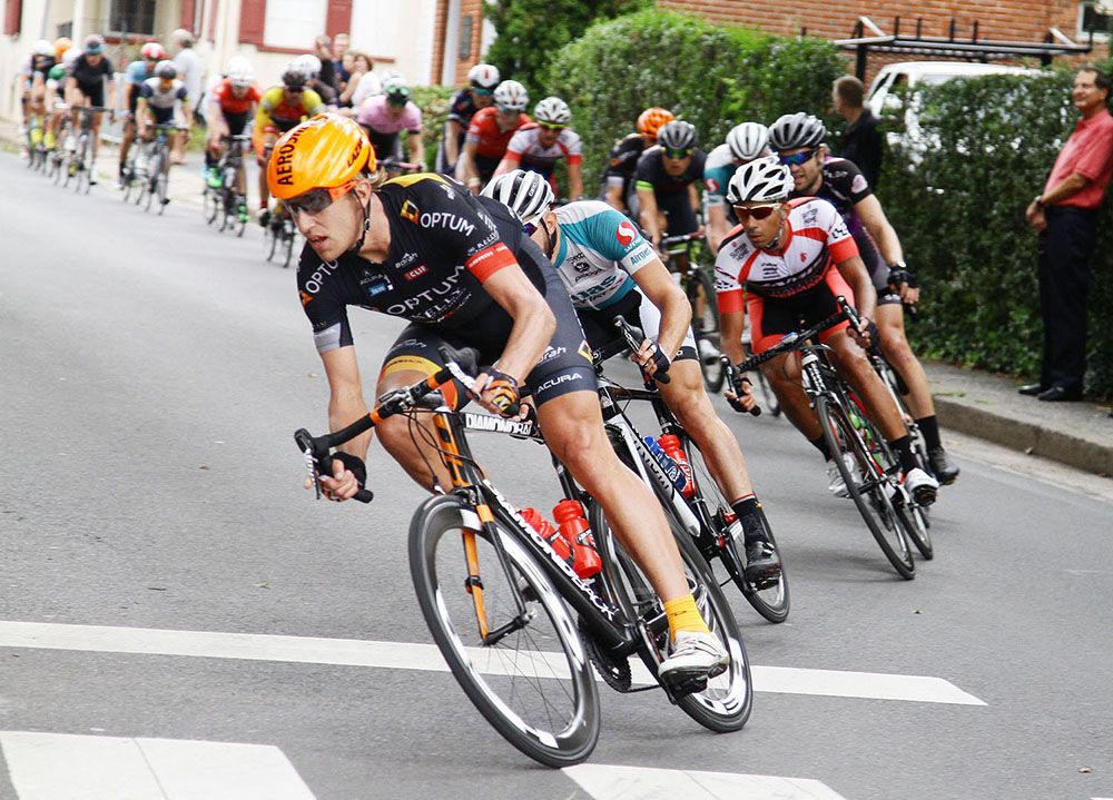Optum p/b Kelly Benefits Tom Zirbel guides the field through turn two.