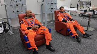 From left: NASA astronauts Victor Glover, Artemis II pilot, and Reid Wiseman, Artemis II commander, conduct leak checks on their spacesuits at NASA's Kennedy Space Center in Florida on April 1, 2026, ahead of the Artemis II launch.