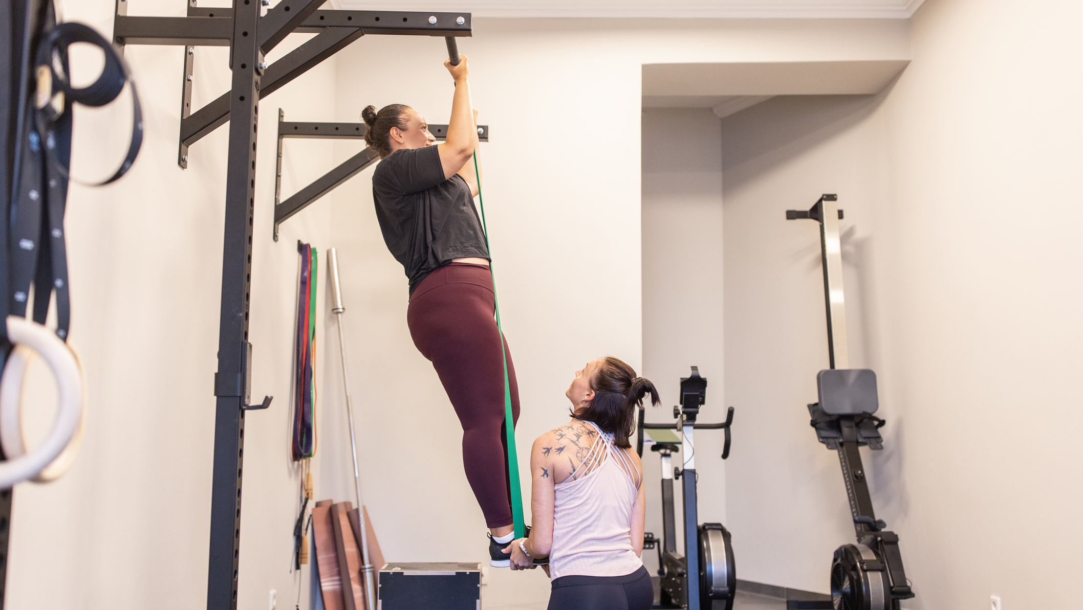 Woman performing an assisted pull-up using a resistance band