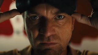 Ewan McGregor's Roman Sionis putting on his black mask in Birds of Prey