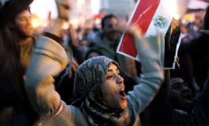 A woman in Tahrir Square celebrates with the crowd after Egyptian President Hosni Mubarak finally gives up power Friday.