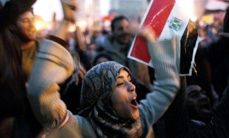 A woman in Tahrir Square celebrates with the crowd after Egyptian President Hosni Mubarak finally gives up power Friday.